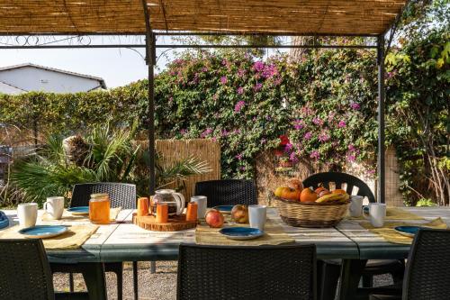 a table with fruit on it in a garden at Casa Stella Di Madel in Flumini di Quartu