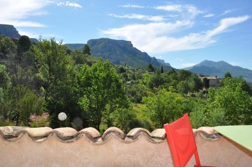 a red chair sitting on top of a roof at Le Jas Du Colombier in Moustiers-Sainte-Marie