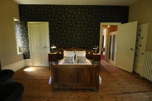 a bedroom with a bed with two pillows on it at Domaine de Champ rose in Saint-Laurent-de-Belzagot