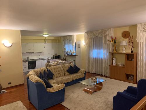a living room with a couch and a table at Vacanze in Puglia in Pezze di Greco