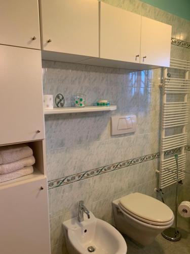 a bathroom with a white toilet and a sink at Vacanze in Puglia in Pezze di Greco