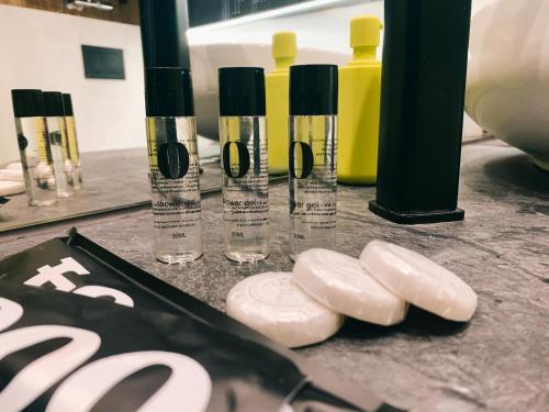 a group of four bottles of liquid on a table at ALEKSANDRA 2 - CONCRETE in Kielce