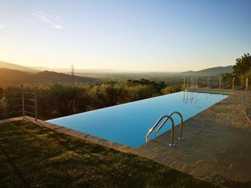 a swimming pool with a view of the mountains at Tenuta San Giovanni Lucca - Borgo Ai Rovai in Lucca