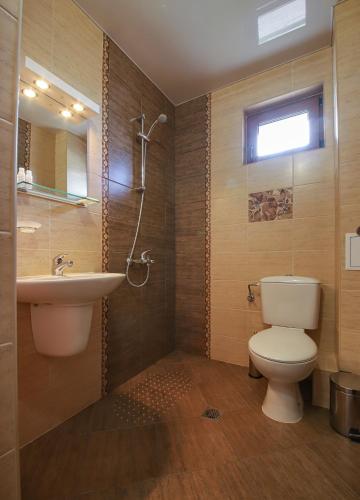 a bathroom with a toilet and a sink at Guesthouse Phoenix in Obzor