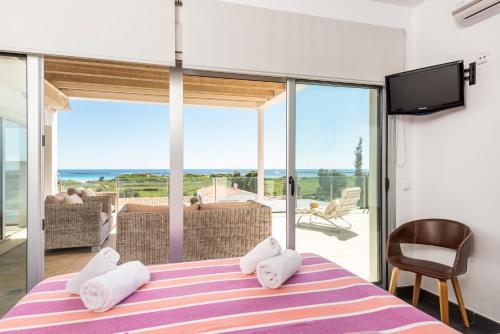 una camera da letto con un letto con vista sull'oceano di Villa Orquidea a Son Bou