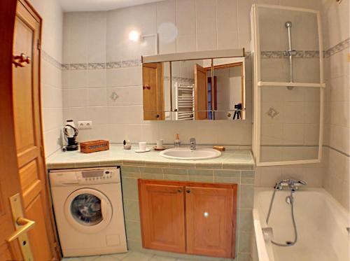 a bathroom with a sink and a washing machine at L'Outa Panoramique in Chamonix