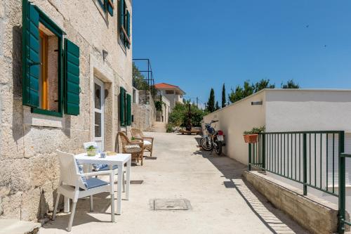 a patio with a table and chairs on a building at Waterview Apartments - Koru Apartment and pool in Mimice