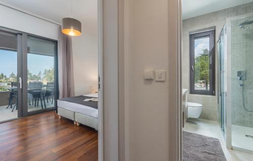 a bedroom with a bed and a bathroom with a shower at SPADA Apartment 3 bedrooms near the beach! in Poreč