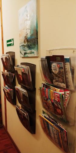 a bunch of magazines hanging on a wall at AL-Tour in Gdynia
