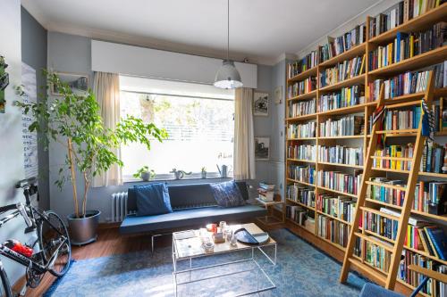 a living room filled with book shelves filled with books at Fred&Breakfast in Ghent