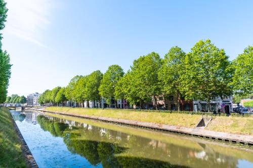 a river with trees on the side of it at Fred&Breakfast in Ghent
