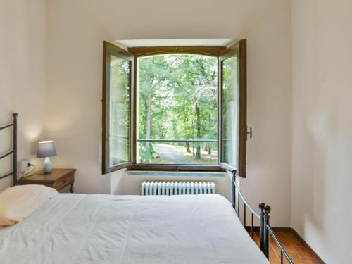 a bedroom with a bed and a window at Farmhouse in Verbania with Lake Views in Verbania
