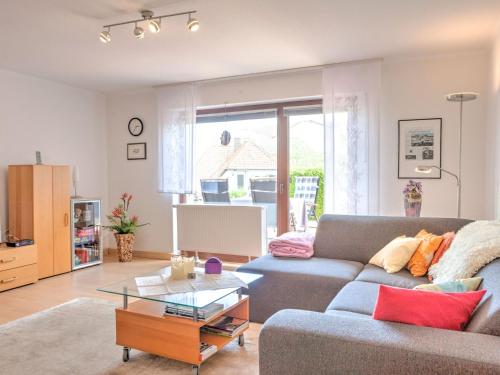 a living room with a couch and a table at Sunny flat in Bad Driburg with garden in Bad Driburg