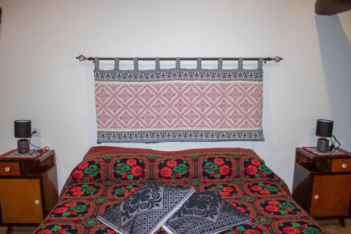 a bedroom with a bed with a patterned blanket on it at B&B Ziu Anacletu in Villaputzu