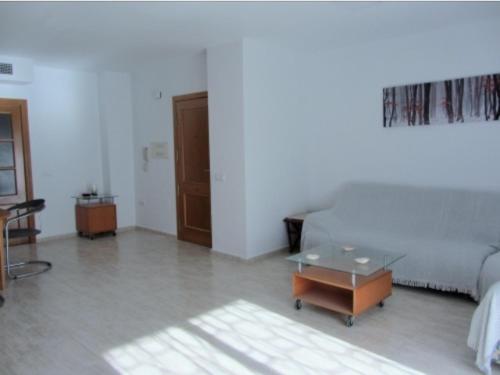 a bedroom with a bed and a table in a room at Apartamento Playa de Garrucha in Garrucha