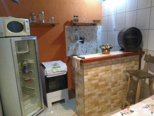 A kitchen or kitchenette at Suites da Dorinha