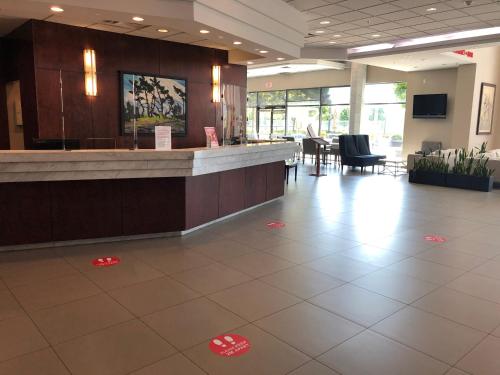 a lobby with a waiting area with red pet tags on the floor at Executive Suites Hotel & Conference Center, Metro Vancouver in Burnaby