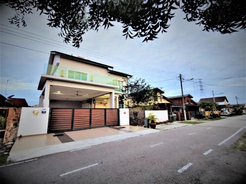 a house on the side of a street with a garage at Warni Villa 13 Whole Or Room in Muar