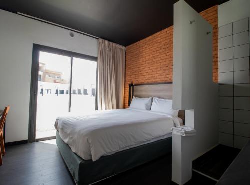 מיטה או מיטות בחדר ב-ONOMO Hotel Dakar