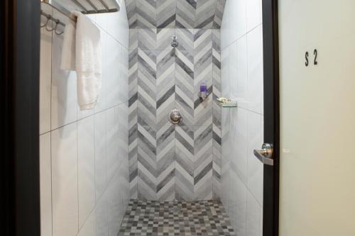 a bathroom with a shower with a checkered floor at Stay Classy in San Diego