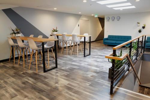 a meeting room with tables and chairs and a blue couch at Stay Classy in San Diego