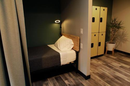 a small bedroom with a bed and a mirror at Stay Classy in San Diego