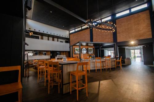 a dining room with wooden tables and chairs at ONOMO Hotel Dakar in Dakar