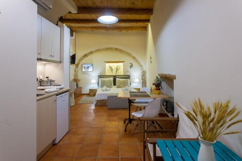 a kitchen and a living room with a table at Charming Flatlet in the Old Town in Chania