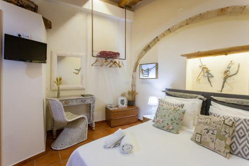 a bedroom with a bed and a table and a mirror at Charming Flatlet in the Old Town in Chania