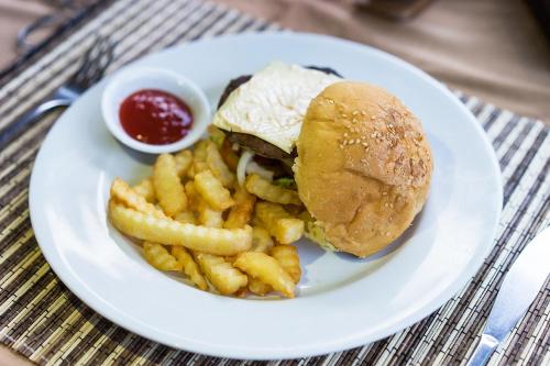 a plate of food with a sandwich and french fries at Le Biu garden View in Nusa Lembongan