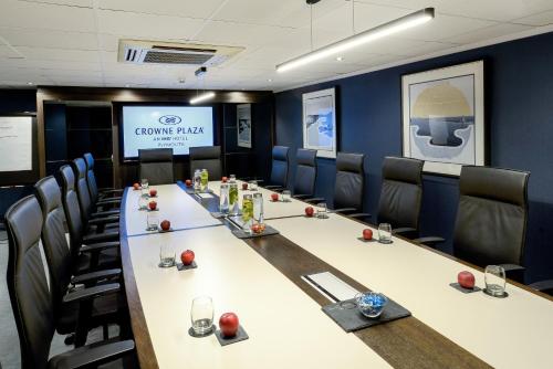 a conference room with a long table and chairs at Crowne Plaza Plymouth by IHG in Plymouth