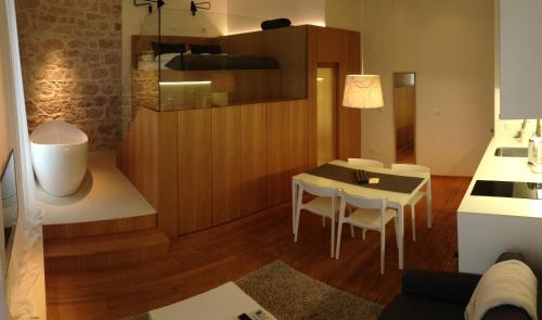 a living room with a table and a dining room at The Bridge Luxury Apartments in Zadar