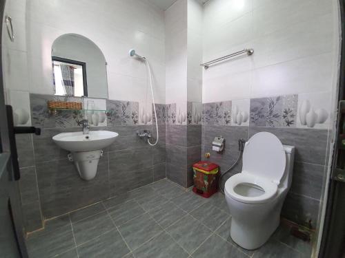 a bathroom with a toilet and a sink at An Phat Hotel in Con Dao