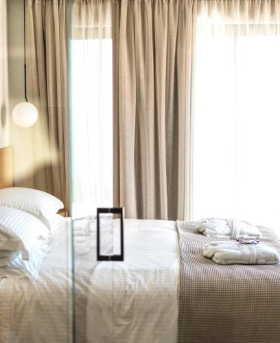 a bedroom with a bed and a window at Mimi and Coco Villas Corfu in Paramonas