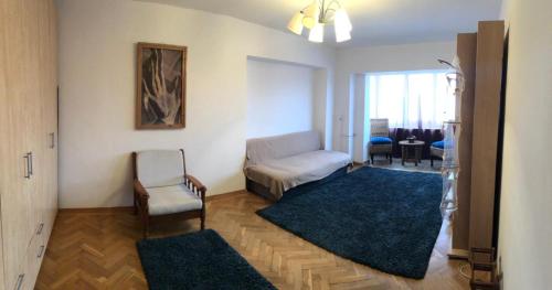 a living room with a couch and a chair at Apartament Central Plaja Modern in Constanţa