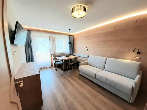 a living room with a couch and a table at Apartments Lasteis in La Villa