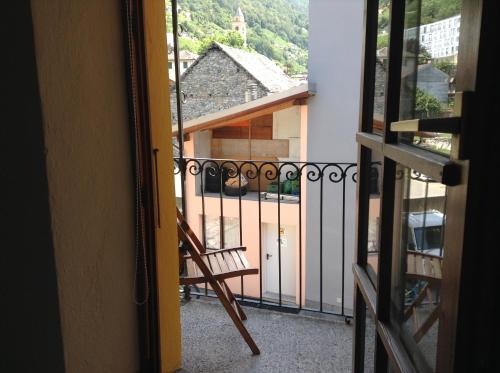 a view of a balcony with a wooden chair at Verzaschina in Gordola