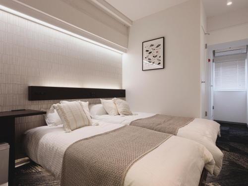 Een bed of bedden in een kamer bij 3rd PLACE by HIDEOUT