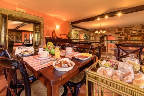 un tavolo in legno con cibo in una stanza di Casal dos Celenis a Caldas de Reis