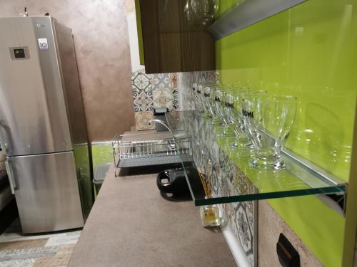 a row of wine glasses are lined up on a counter at Sea View Marina Dinevi Apartments - Tryavna Beach in Sveti Vlas