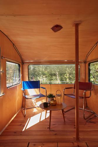 a room with two chairs and a table in a train car at La Belle Folie in Ploemel