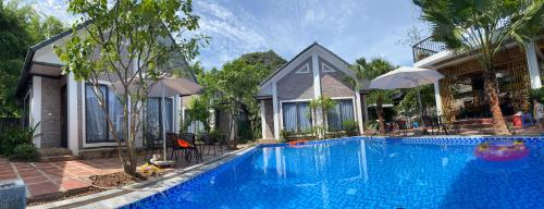 a swimming pool in front of a house at Tam Coc Golden Rice in Ninh Binh