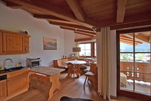 a kitchen and living room with a table and a dining room at Ferienhaus Elisabeth in Ellmau