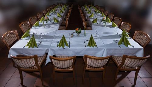 a long table with white table cloth and chairs at Hotel Dorheimer Hof in Friedberg
