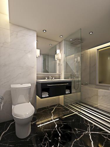 a bathroom with a toilet and a sink at Meliá Kuala Lumpur in Kuala Lumpur