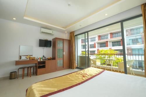 a bedroom with a bed and a large window at Anise hotel in Phu Quoc