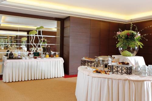 a buffet line with white tables with food on them at InterContinental Mzaar Lebanon Mountain Resort & Spa by IHG in Kfardebian