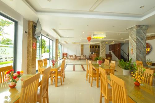 a dining room with wooden tables and chairs at Anise hotel in Phu Quoc