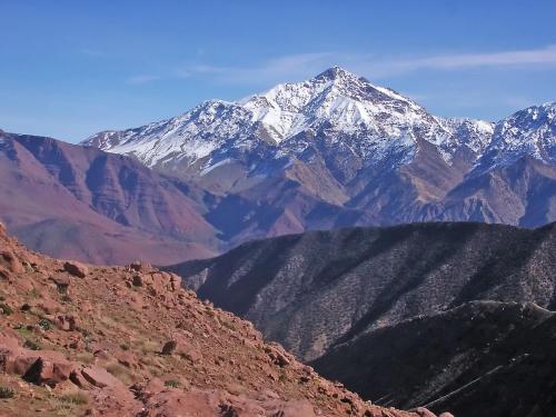 a mountain range with snow capped mountains in the distance at Kasbah Angour in Tahannout