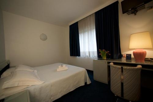 a hotel room with a bed and a window at Club Hotel in Mestre